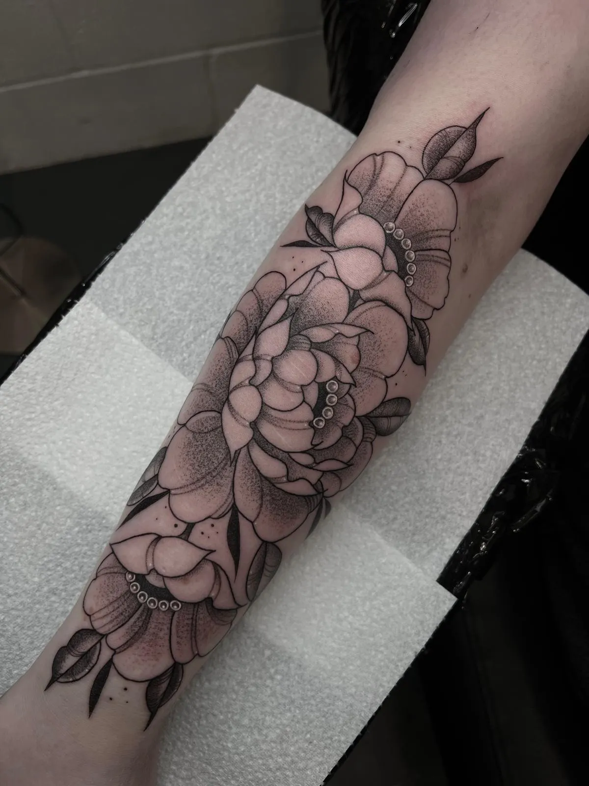 Fine line floral forearm sleeve with stipple shading and pearl detail by Ashlee at Shade Studio Peterborough