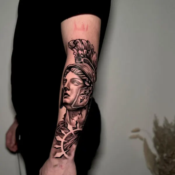 Black and grey Greek statue with plumed helmet, forearm tattoo by Cameron at Shade Studio Peterborough