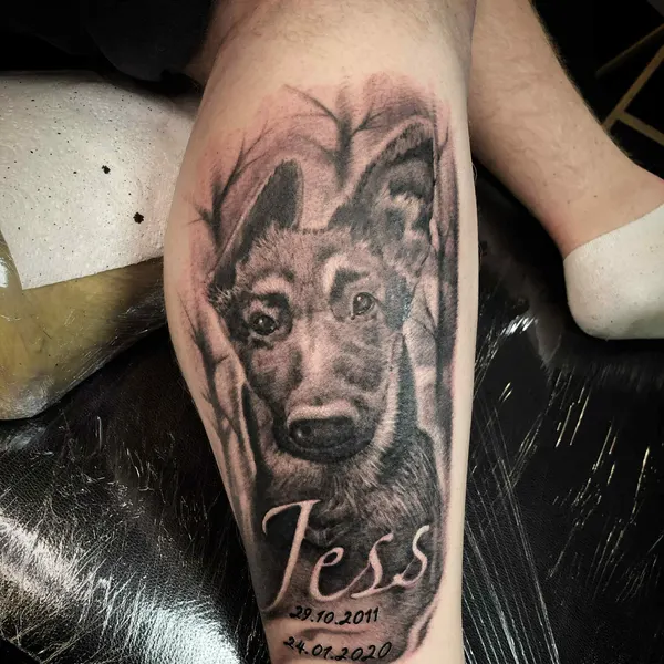 black and grey dog portrait with a name and memorial dates, forearm piece by raf