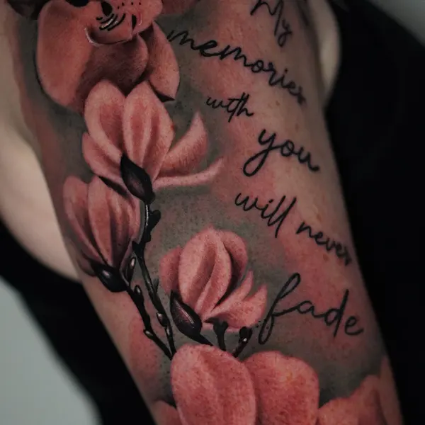 delicate black and grey flowers wrapped around a memorial line by jason, upper arm