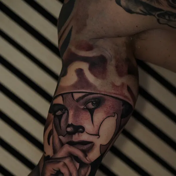 chicano clown-face woman portrait built into a full upper arm sleeve