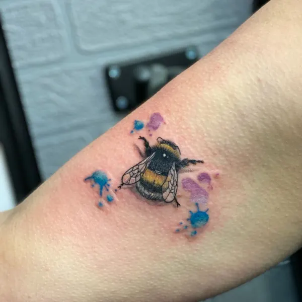 colour bee with a soft purple watercolour splash, forearm piece by karolina