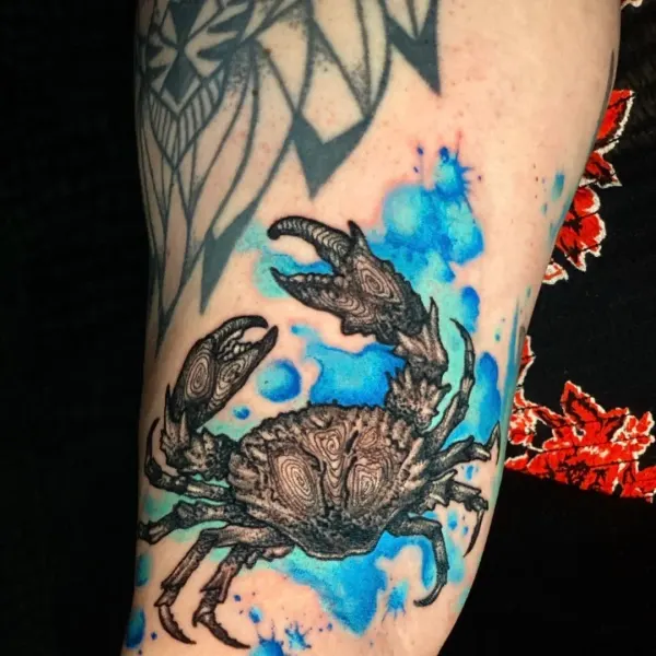 Detailed crab with blue watercolour splash, arm tattoo by Karolina at Shade Studio Peterborough