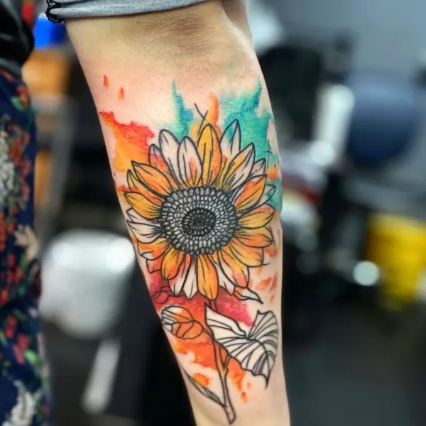 Watercolour sunflower forearm tattoo in bright colour by Karolina at Shade Studio Peterborough
