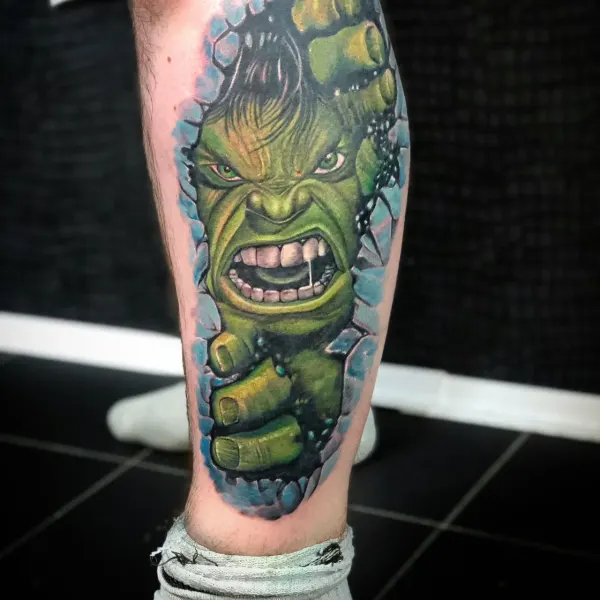 Colour Hulk bursting through a brick wall, calf tattoo by Raf at Shade Studio Peterborough
