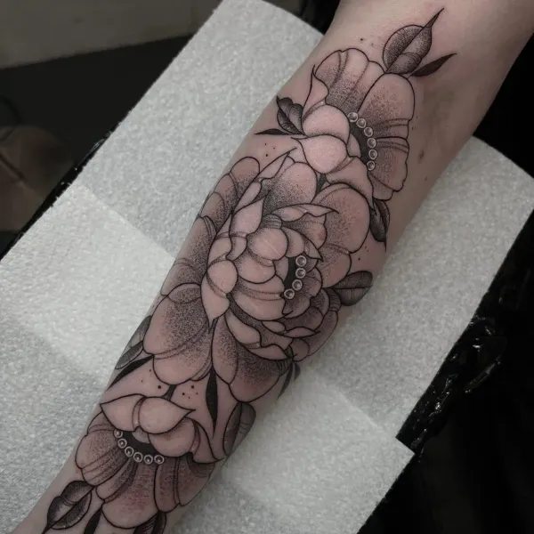 Fine line floral forearm sleeve with stipple shading and pearl detail by Ashlee at Shade Studio Peterborough
