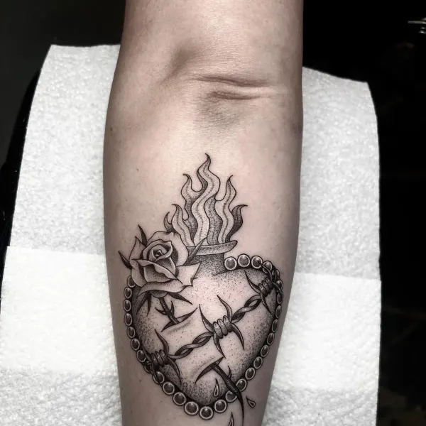 Sacred heart with flames, rose, barbed wire and pearl border, forearm tattoo by Ashlee at Shade Studio Peterborough