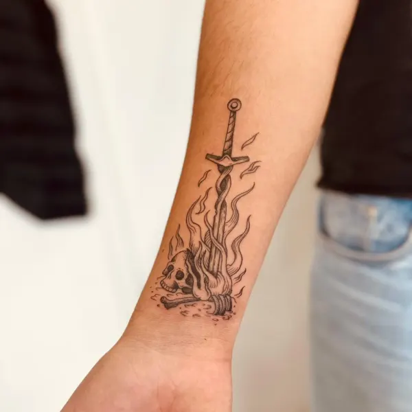 Flaming sword with skull and bones in fine line, forearm tattoo by Hannah at Shade Studio Peterborough