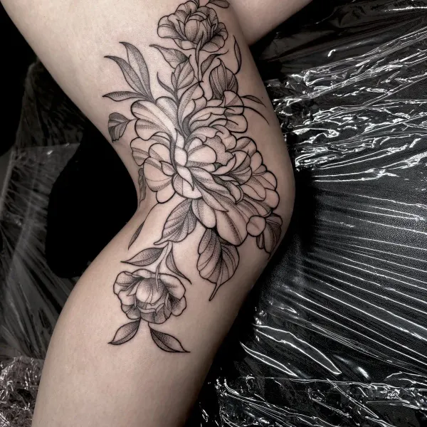 Peonies in fine line with stipple shading, thigh tattoo by Lana at Shade Studio Peterborough