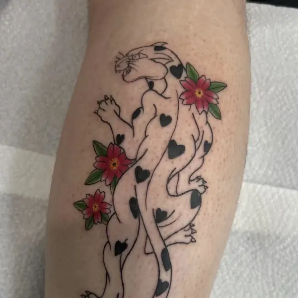 Fine line panther with heart shaped spots and red flowers, calf tattoo by Madi at Shade Studio Peterborough