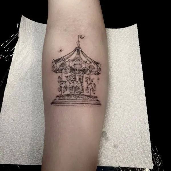 Fairground carousel in stipple shading, forearm tattoo by Lana at Shade Studio Peterborough