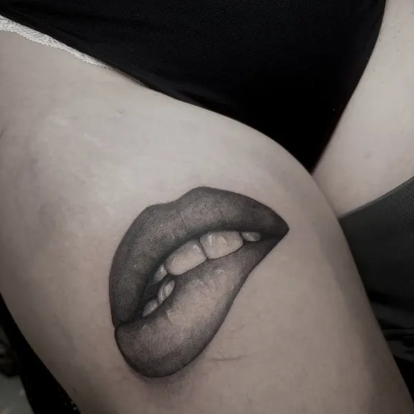 Lips with tongue in smooth stipple shading, thigh tattoo by Lana at Shade Studio Peterborough