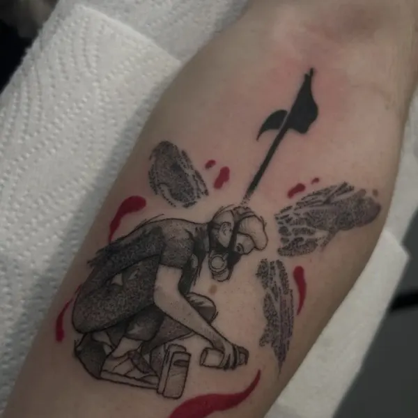 Stipple shaded figure in a gas mask with an axe and red splatter, forearm tattoo by Madi at Shade Studio Peterborough