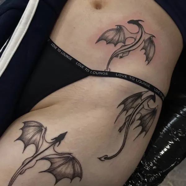 Three stipple shaded dragons in flight across the hip and thigh by Madi at Shade Studio Peterborough